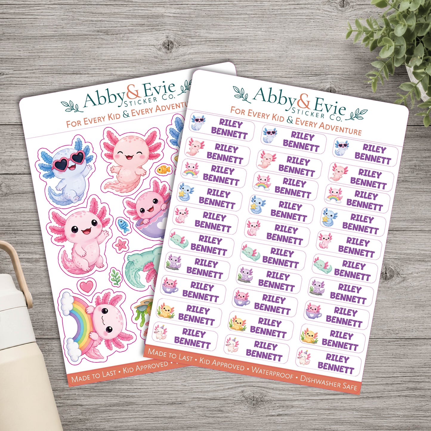 Two sheets of Abby & Evie Sticker Co. planner stickers featuring cute cartoon characters, animals, and the name 'Riley Bennett' repeated across the sheets, arranged on a gray wood background.