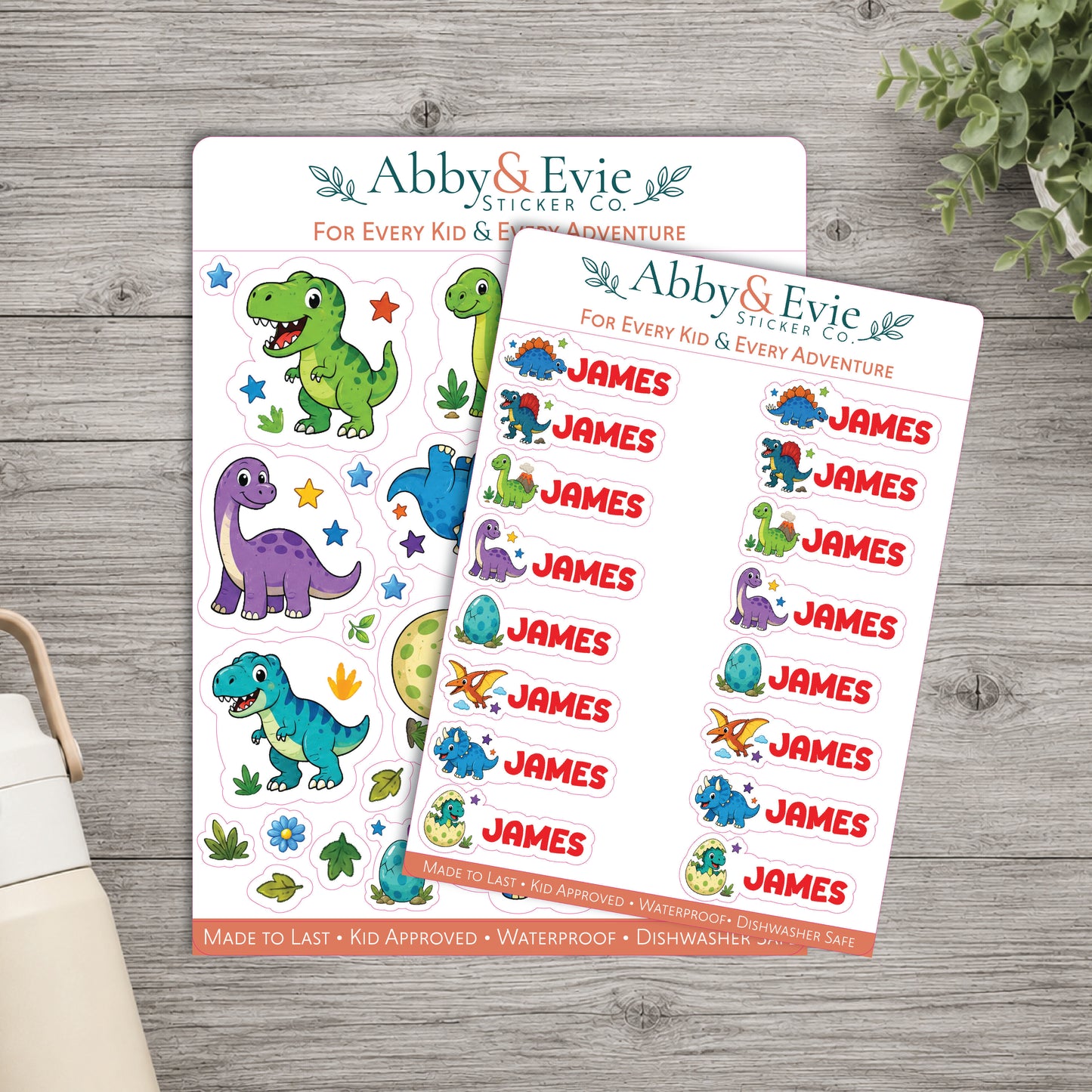 Two personalized dinosaur-themed sticker sheets from Abby & Evie Sticker Co. displayed on a gray wood background, with one sheet showing blank dinosaur stickers and the other showing the name 'JAMES' repeated next to each dinosaur.