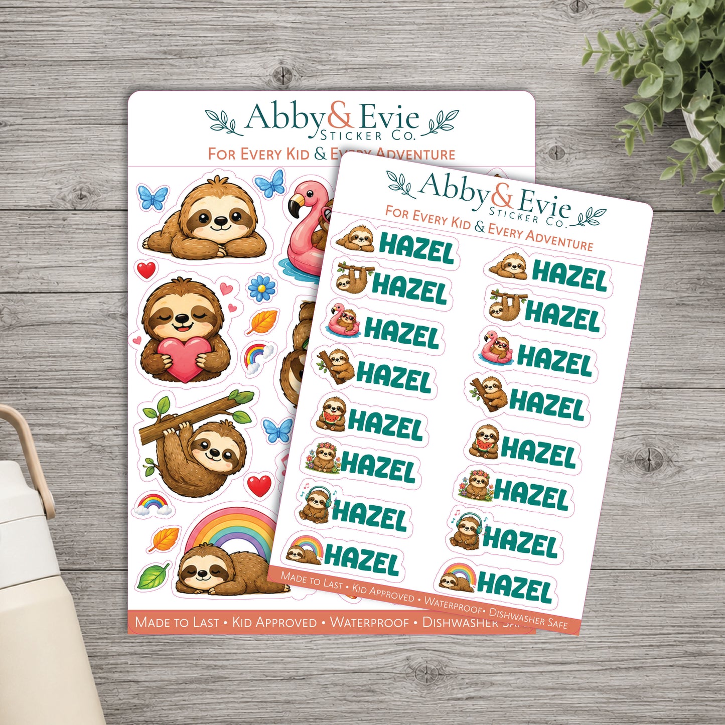 Two sticker sheets from Abby & Evie Sticker Co. featuring cute sloth illustrations and repeated 'Hazel' name stickers, arranged on a gray wood surface with a small plant and part of a bag visible at the edges.