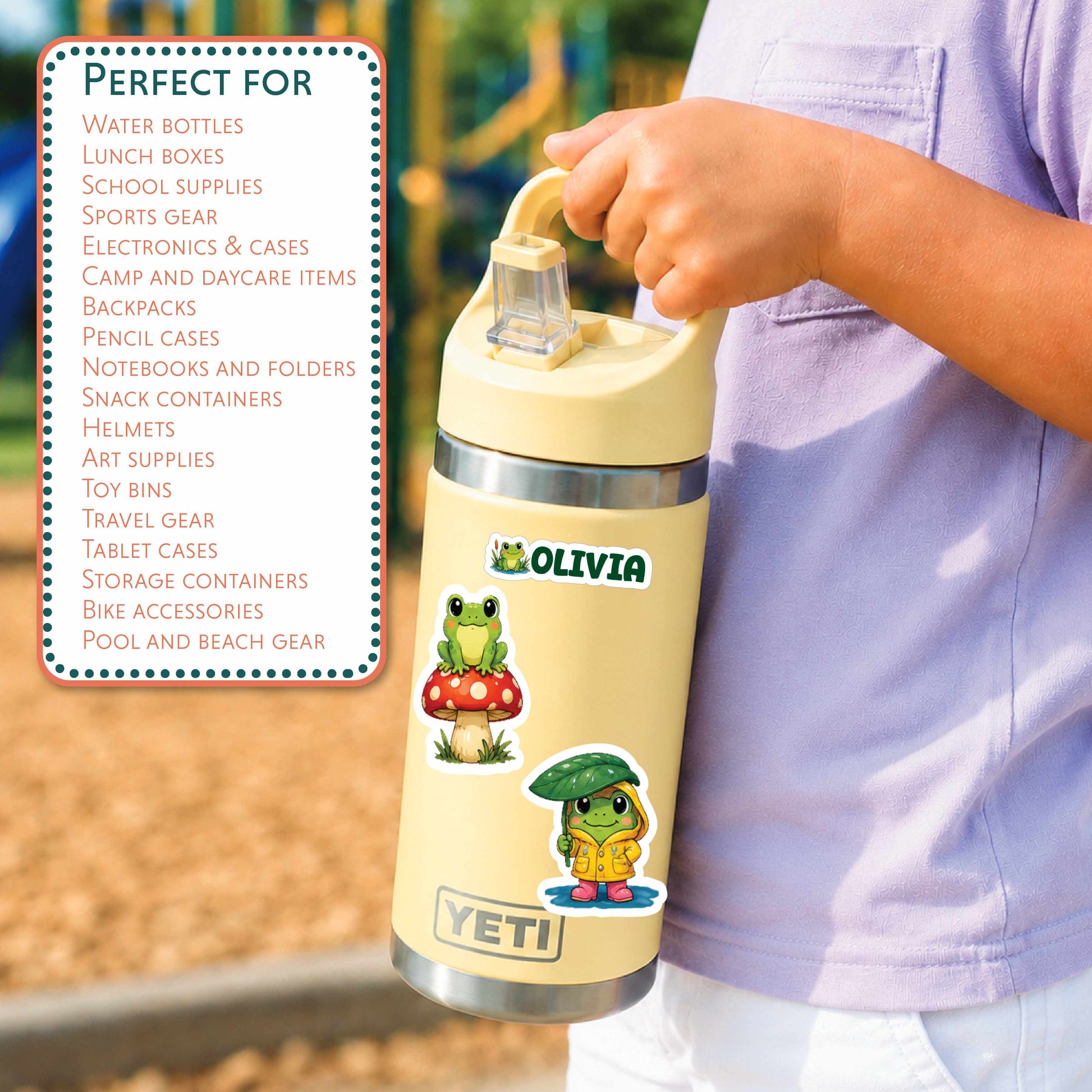 A person holding a YETI water bottle outdoors, with a printed graphic on the left listing compatible product types such as water bottles, lunch boxes, and school supplies. The bottle is cream-colored with cartoon frog and puddle character decals and a silver metal neck.
