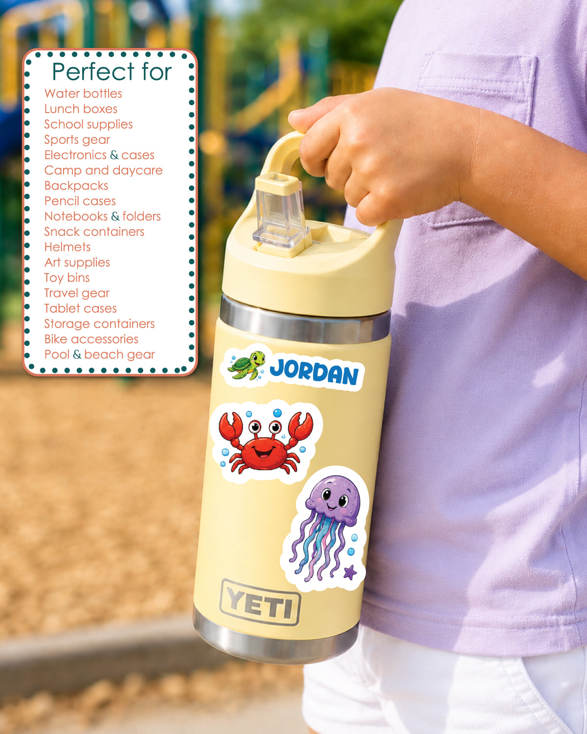 A person in a light purple shirt holds a beige YETI water bottle with a lid. The bottle has a cartoon crab and jellyfish sticker on it.